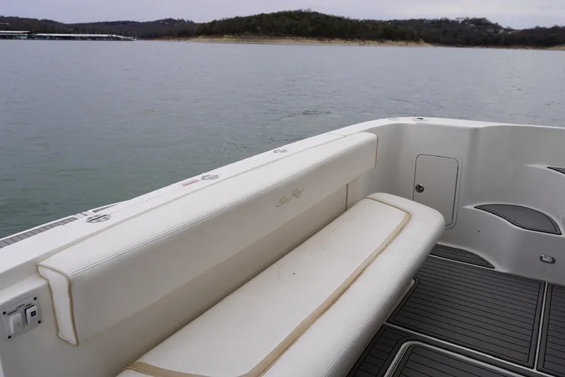 Slide: The Image of 2009 Sea Ray 47 Sedan Bridge boat interior with seating, on calm water. - 26