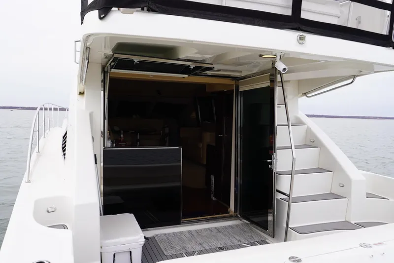 Slide: The Image of 2009 Sea Ray 47 Sedan Bridge yacht with open cabin door and exterior stairs. - 27