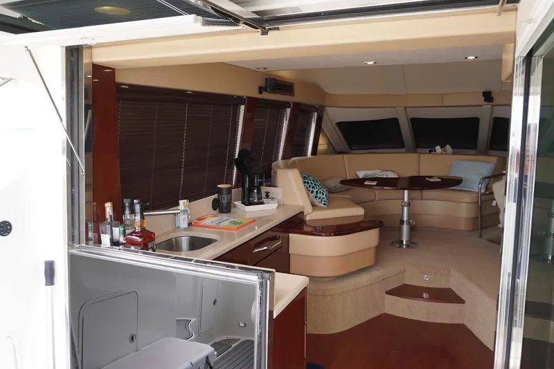 Slide: The Image of Luxurious interior of 2009 Sea Ray 47 Sedan Bridge yacht with kitchen and seating area. - 28