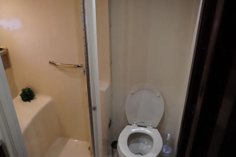 Slide: The Image of Bathroom interior of 2009 Sea Ray 47 Sedan Bridge yacht, featuring toilet and shower area. - 38