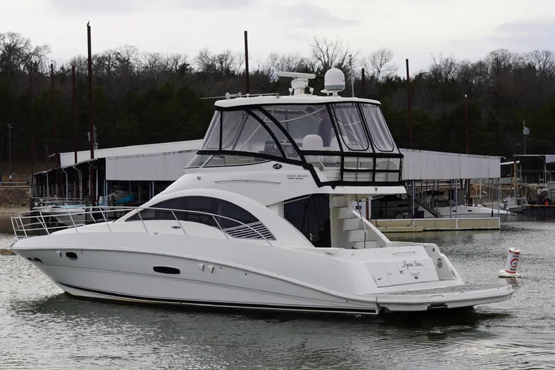 Slide: The Image of 2009 Sea Ray 47 Sedan Bridge yacht docked in a marina, side view. - 4