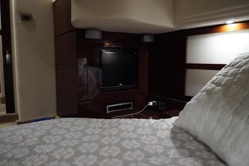 Slide: The Image of Luxurious interior of 2009 Sea Ray 47 Sedan Bridge with TV and cozy bedding. - 43