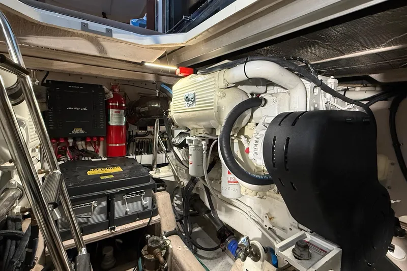 Slide: The Image of Engine room of 2009 Sea Ray 47 Sedan Bridge with visible components and fire extinguisher. - 49