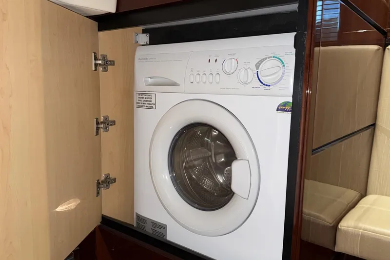 Slide: The Image of Washing machine inside 2009 Sea Ray 47 Sedan Bridge yacht's wooden cabinet. - 54