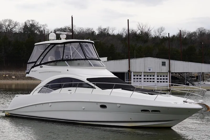 Slide: The Image of 2009 Sea Ray 47 Sedan Bridge yacht docked on a calm lake. - 8