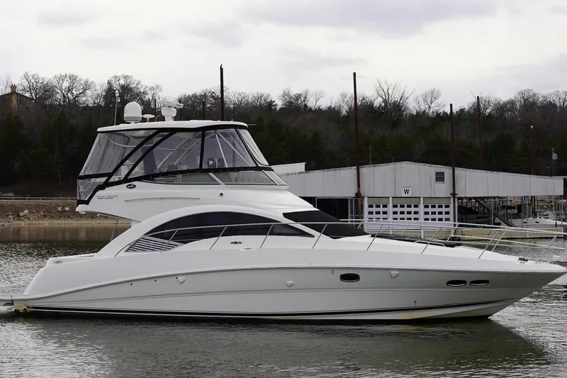 Slide: The Image of 2009 Sea Ray 47 Sedan Bridge yacht docked on a calm lake. - 9