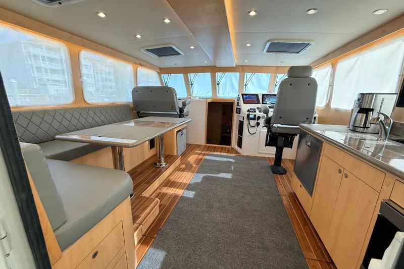 Slide: The Image of 2025 Wesmac 42 boat with Simrad radar system, docked near waterfront buildings. - 14