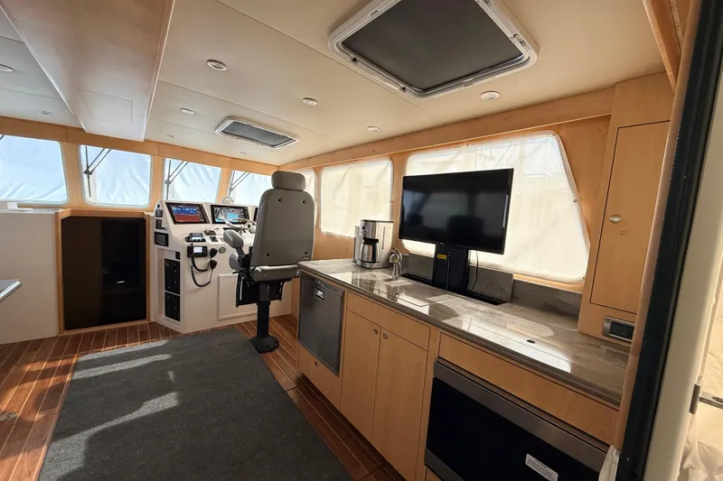 Slide: The Image of Luxurious interior of 2025 Wesmac 42 yacht with modern seating and navigation area. - 17