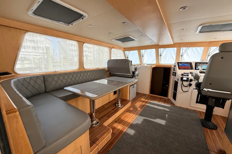 Slide: The Image of Luxurious interior of 2025 Wesmac 42 boat with modern seating and wood flooring. - 18