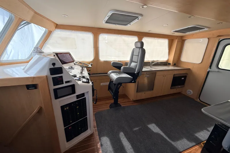 Slide: The Image of Luxurious interior of 2025 Wesmac 42 boat with modern seating and navigation equipment. - 21