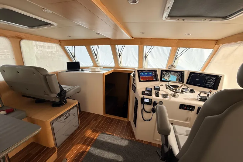 Slide: The Image of Modern interior of 2025 Wesmac 42 boat with helm and kitchenette. - 23