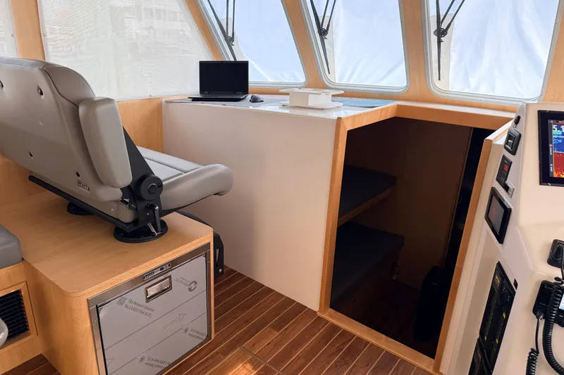 Slide: The Image of 2025 Wesmac 42 boat interior with modern navigation equipment and comfortable seating. - 25