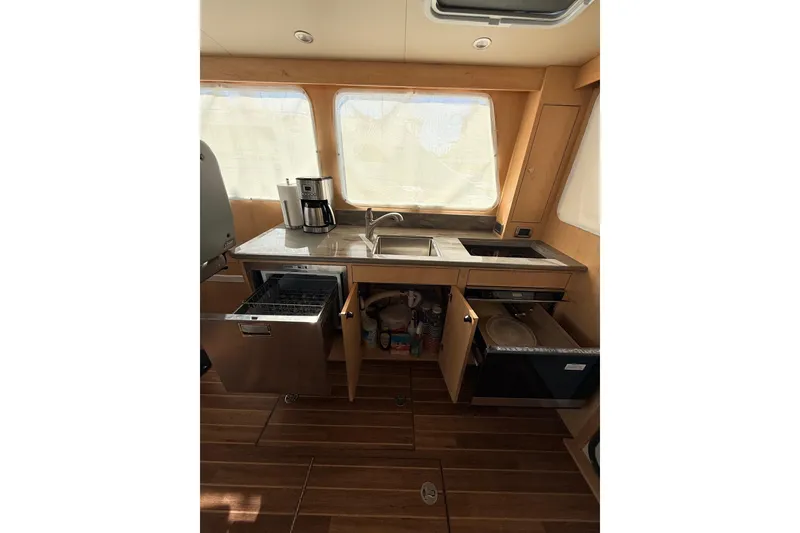 Slide: The Image of 2025 Wesmac 42 boat interior with modern navigation equipment and seating. - 26