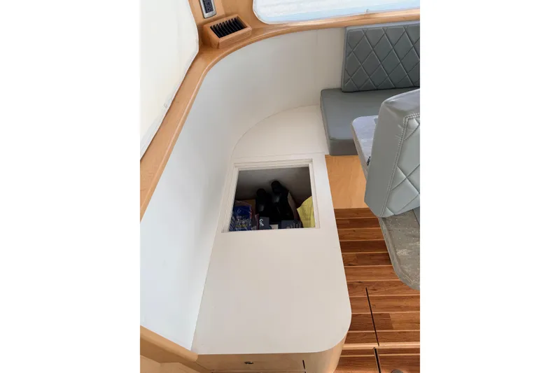 Slide: The Image of Interior of 2025 Wesmac 42 boat cockpit with advanced navigation controls and captain's chair. - 27