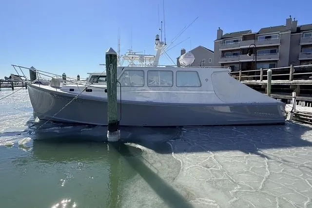 Slide: The Image of 2025 Wesmac 42 boat docked on a sunny day near waterfront buildings. - 3