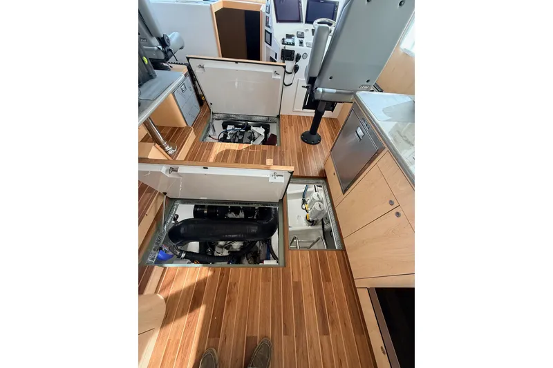 Slide: The Image of Interior of 2025 Wesmac 42 boat with open storage compartment and seating area. - 30