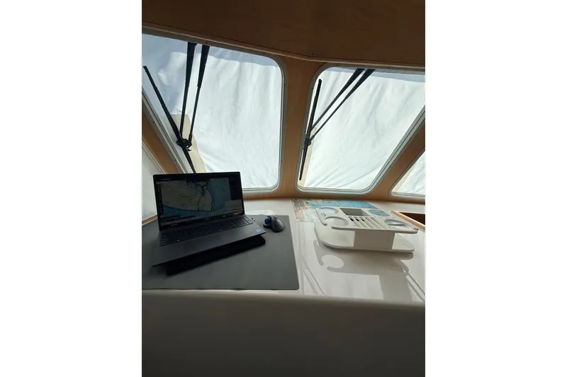 Slide: The Image of Interior view of 2025 Wesmac 42 boat showing open engine compartments and control area. - 33