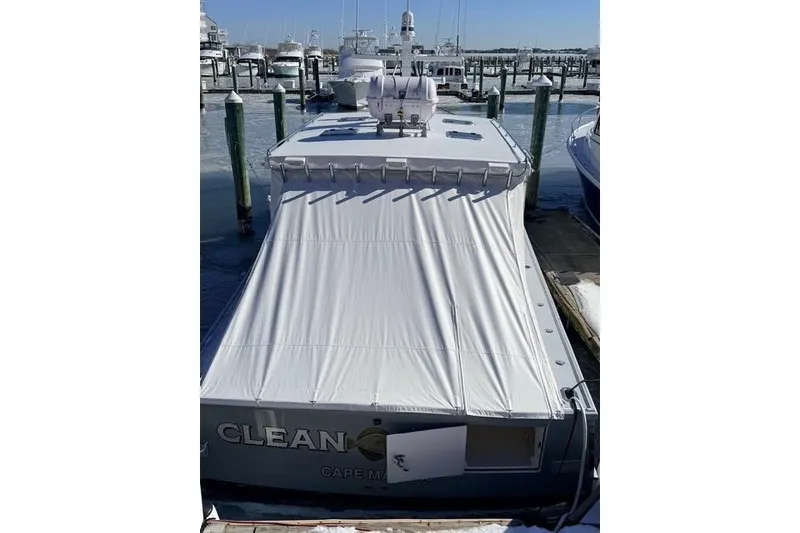 Slide: The Image of 2025 Wesmac 42 boat docked with protective cover in marina. - 4