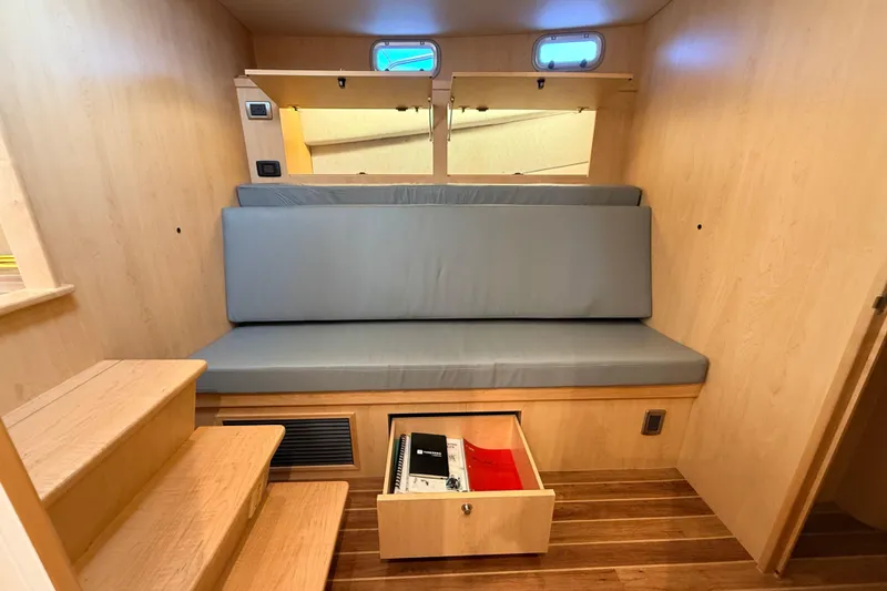 Slide: The Image of 2025 Wesmac 42 interior with wooden bunk beds and storage compartments. - 44