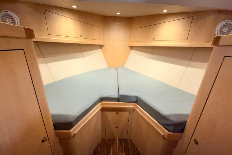 Slide: The Image of 2025 Wesmac 42 interior with wooden finish and cushioned seating area. - 46