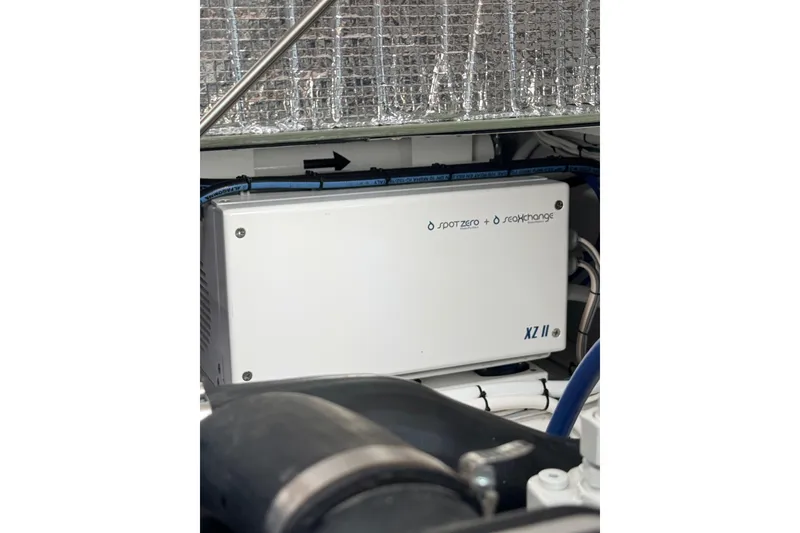 Slide: The Image of 2025 Wesmac 42 interior cabin with wooden finish and blue cushions. - 49