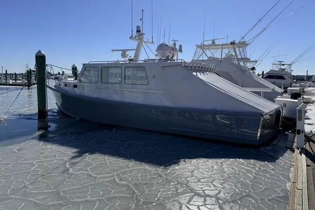 Slide: The Image of 2025 Wesmac 42 boat docked on icy water near waterfront buildings. - 5