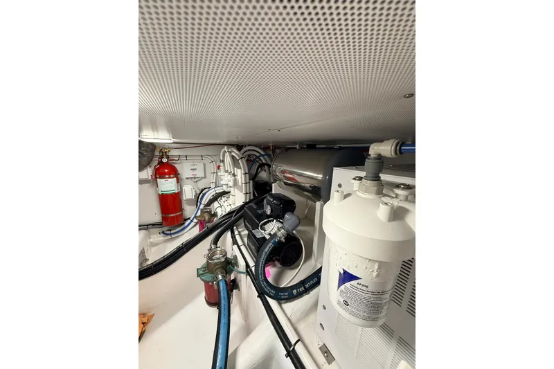 Slide: The Image of 2025 Wesmac 42 boat interior cabin with storage compartments and wooden finish. - 50