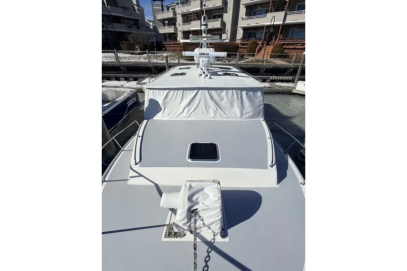 Slide: The Image of 2025 Wesmac 42 boat docked in marina, sleek design, clear blue sky. - 6