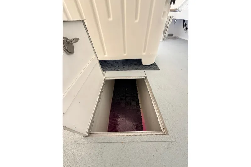 Slide: The Image of Open hatch on 2025 Wesmac 42 boat deck, revealing storage compartment. - 67