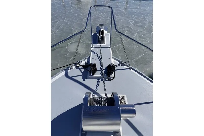 Slide: The Image of 2025 Wesmac 42 boat docked with protective cover in marina. - 7