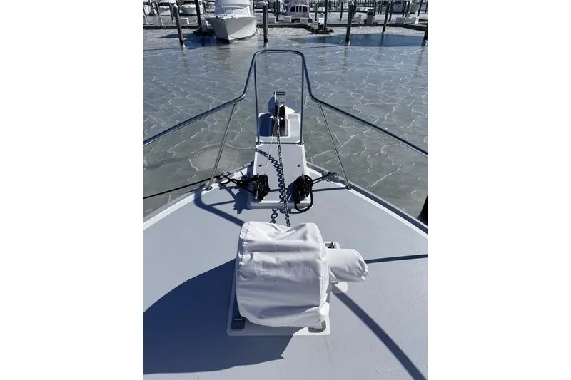 Slide: The Image of 2025 Wesmac 42 boat docked on icy water under clear blue sky. - 8