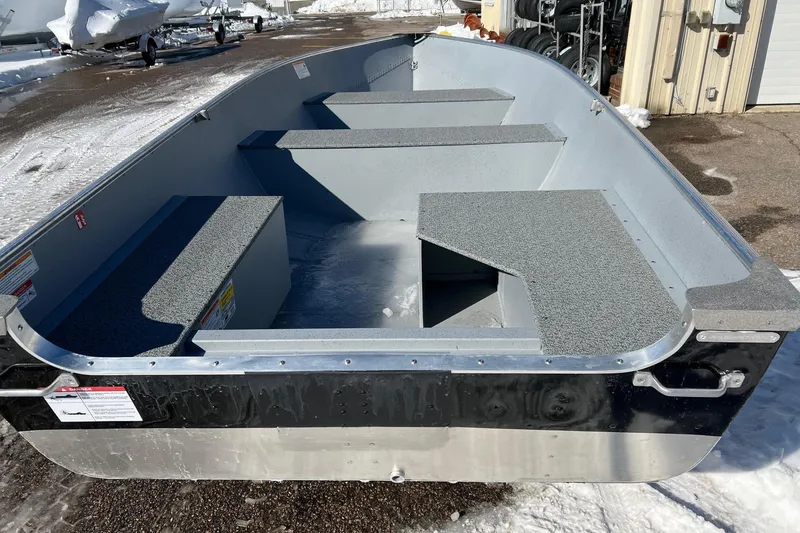 Slide: The Image of 2026 Lund WC-16 boat with gray interior, parked on snowy ground. - 10