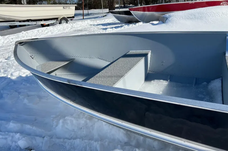 Slide: The Image of 2026 Lund WC-16 boat in snowy setting, showcasing interior and sleek design. - 3