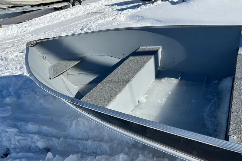 Slide: The Image of 2026 Lund WC-16 boat on snowy ground, showcasing interior seating and aluminum construction. - 4