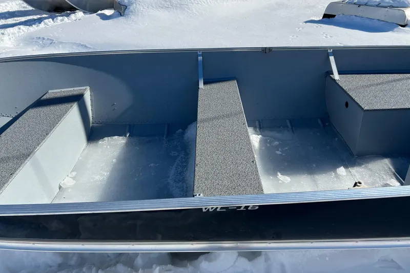 Slide: The Image of 2026 Lund WC-16 boat interior with snow-covered seats and flooring. - 5