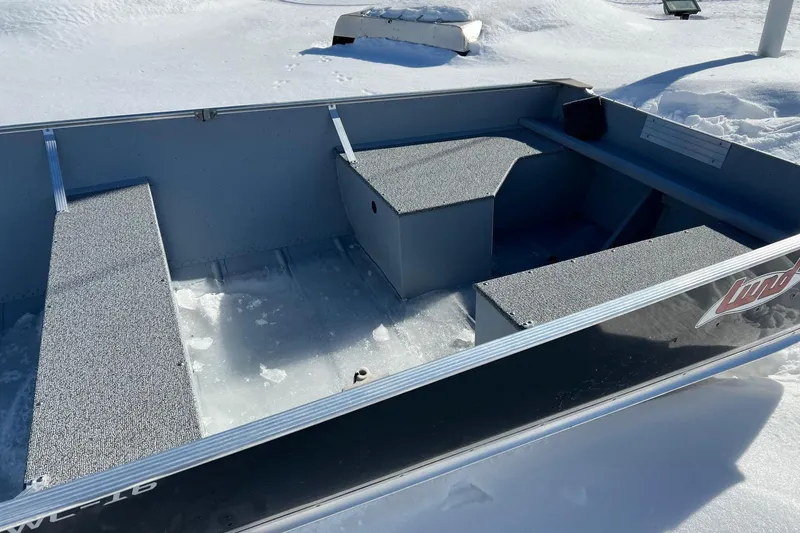 Slide: The Image of 2026 Lund WC-16 boat on snow, showcasing interior seating and storage. - 6