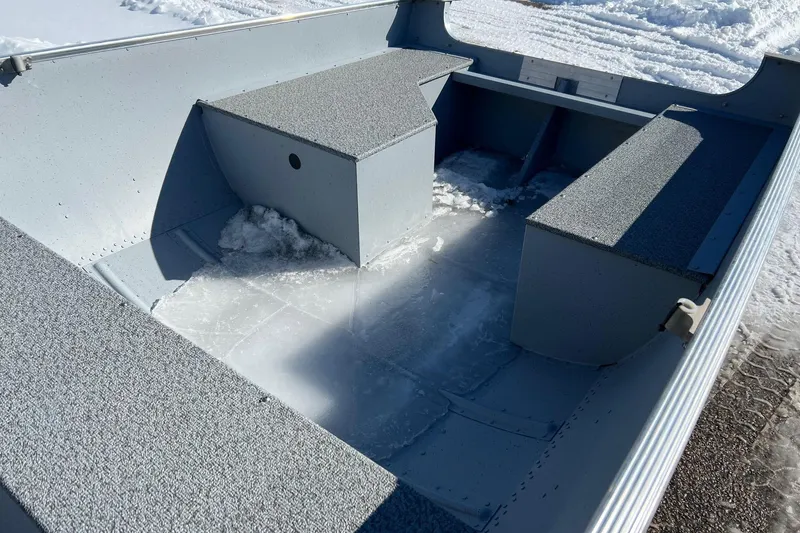 Slide: The Image of 2026 Lund WC-16 boat interior with snow, showcasing seating and storage. - 9