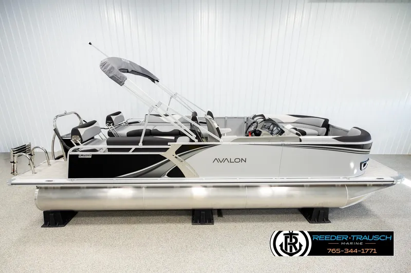 The Image of 2026 Avalon LSZ QLS pontoon boat in showroom, featuring sleek design and modern amenities. - 1