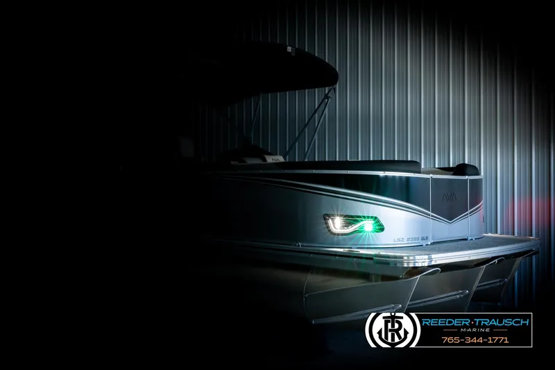 Slide: The Image of 2026 Avalon LSZ QLS pontoon boat in dimly lit showroom, showcasing sleek design. - 4