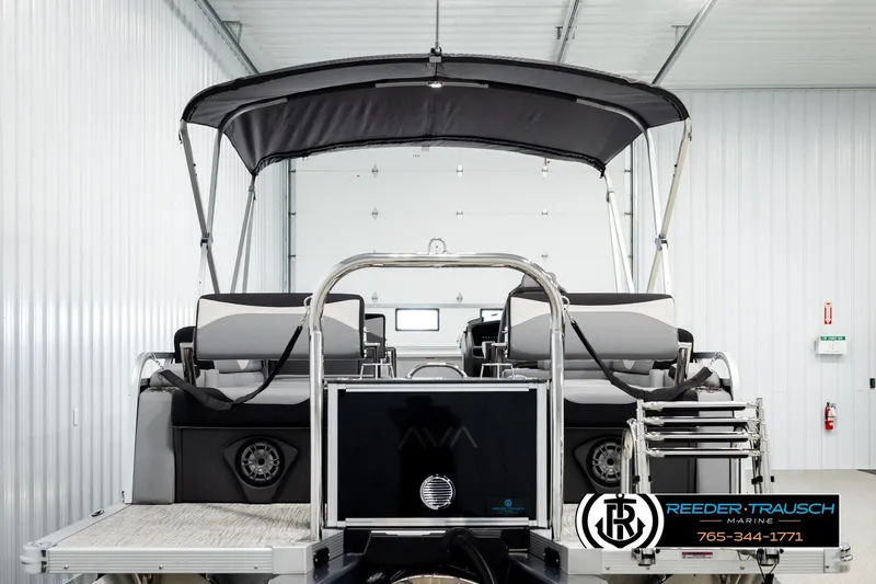 Slide: The Image of 2026 Avalon LSZ QLS pontoon boat in showroom, featuring sleek design and modern amenities. - 7