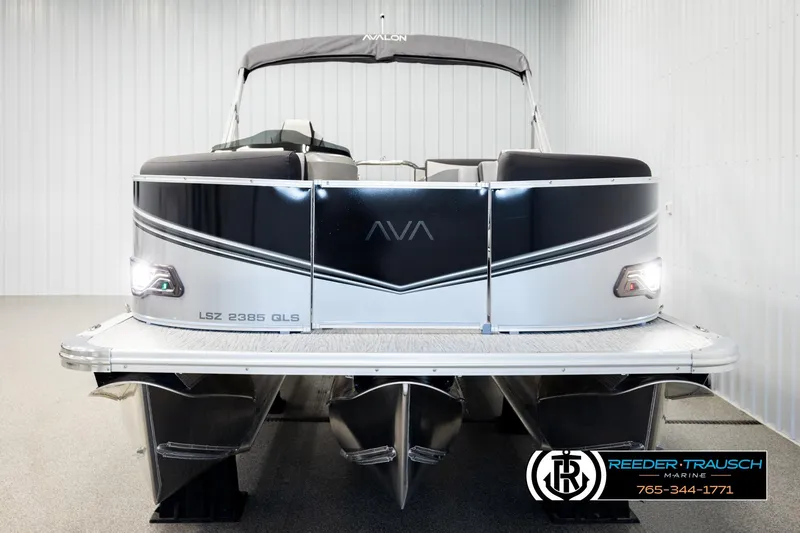 Slide: The Image of 2026 Avalon LSZ QLS pontoon boat in showroom, front view with sleek design. - 8