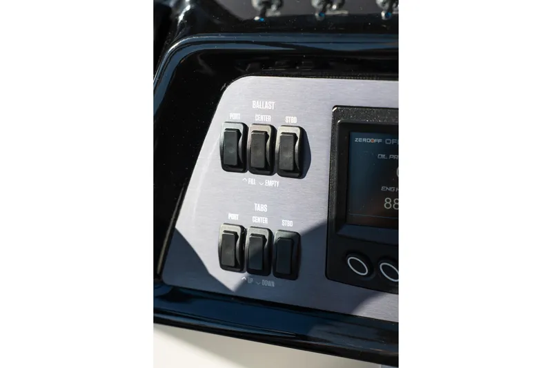 Slide: The Image of 2023 MasterCraft NXT22 control panel with ballast and tab switches. - 10