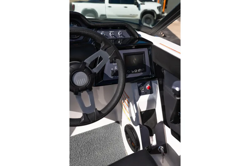 Slide: The Image of 2023 MasterCraft NXT22 boat dashboard with steering wheel and control panel. - 12