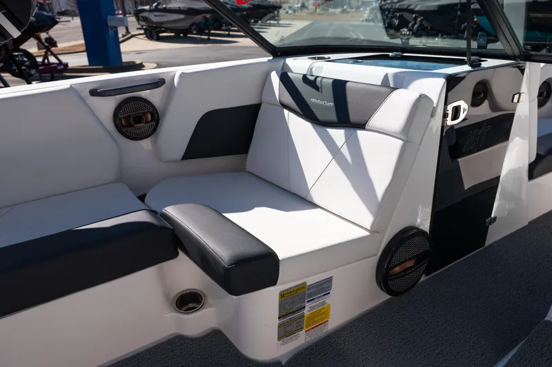Slide: The Image of 2023 MasterCraft NXT22 boat interior with white and black seating, featuring built-in speakers. - 15