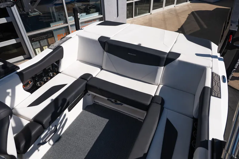 Slide: The Image of 2023 MasterCraft NXT22 boat interior with sleek black and white seating design. - 17
