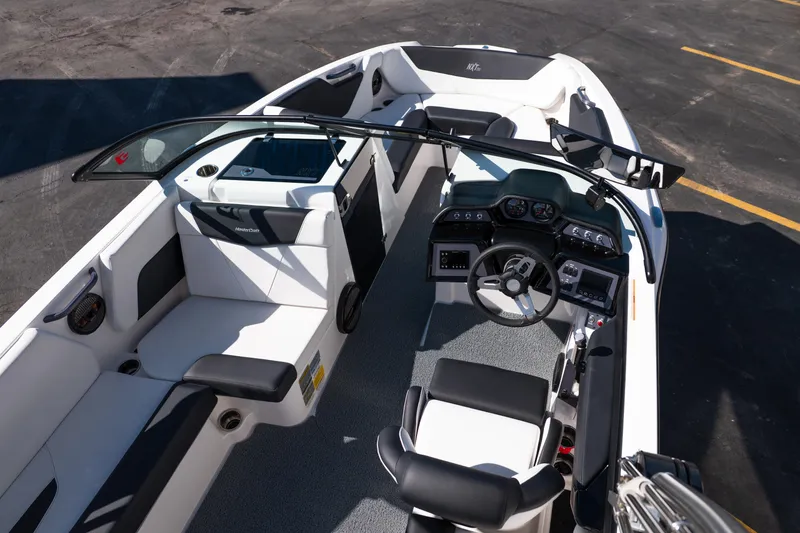 Slide: The Image of 2023 MasterCraft NXT22 boat interior with modern dashboard and seating. - 19