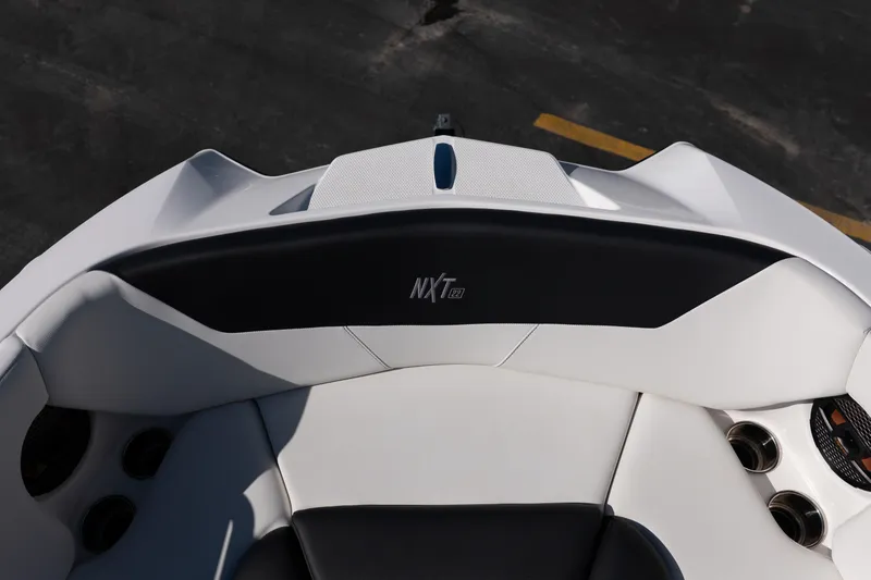 Slide: The Image of 2023 MasterCraft NXT22 boat interior with sleek seating and cup holders. - 21