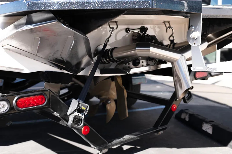 Slide: The Image of 2023 MasterCraft NXT22 boat rear view, showcasing exhaust and propeller details. - 22