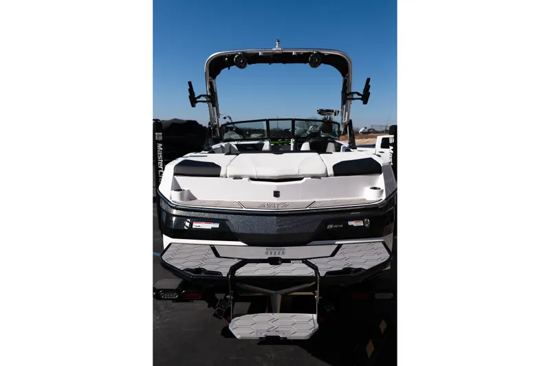 Slide: The Image of 2023 MasterCraft NXT22 boat with sleek design and modern features, viewed from the rear. - 23