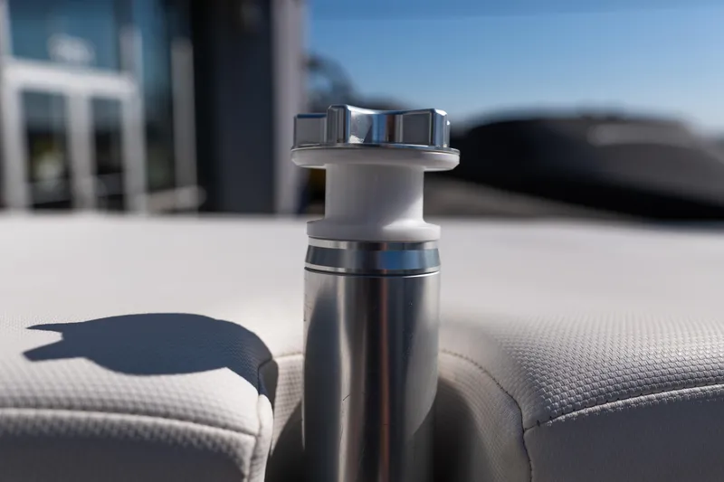 Slide: The Image of 2023 MasterCraft NXT22 boat detail, featuring a stainless steel cleat on white upholstery. - 27